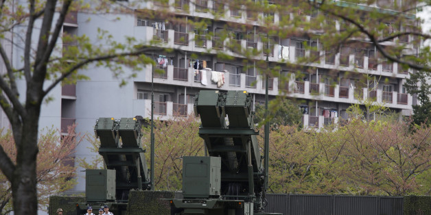 Units of Patriot Advanced Capability-3 (PAC-3) missiles stand in front of a housing complex, at the Defence Ministry in Tokyo April 9, 2013. Japanese public broadcaster NHK showed aerial footage of what it said were ballistic missile interceptors being deployed near Tokyo in response to North Korea's threats and actions. Japan in the past has deployed ground-based PAC-3 interceptors, as well as Aegis radar-equipped destroyers carrying Standard Missile-3 (SM-3) interceptors in the run-up to North Korean missile launches. REUTERS/Issei Kato (JAPAN - Tags: POLITICS MILITARY)