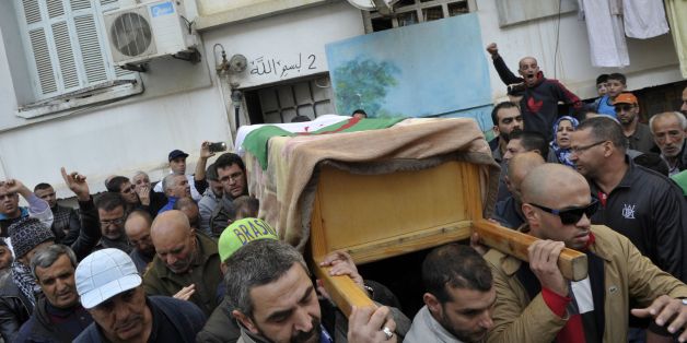 Relatives and friends leave the family house carrying the body of British-Algerian journalist Mohamed Tamalt before going to the cemetery during his funeral, on December 12, 2016 in Algiers.Mohamed Tamalt died on December 11, 2016 after having staged a hunger strike to protest a two-year jail term for offending Algeria's president in a poem posted online, his lawyer said. / AFP / RYAD KRAMDI (Photo credit should read RYAD KRAMDI/AFP/Getty Images)