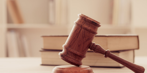 Closeup wooden judges gavel on wooden table with legal books. retro style. soft focus.