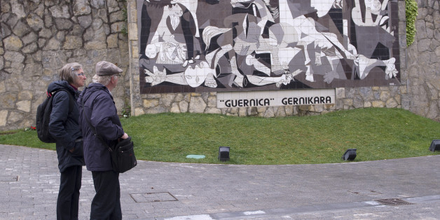 A couple watch a mural depicting Picasso's painting 'Guernica' in the Spanish northern Basque village of Gernika on April 26, 2017.Guernica commemorates today the 80th aniversary of the bombing raid of the small Basque town of Guernica by Nazi aircraft, at the behest of General Francisco Franco on 1937. / AFP PHOTO / ANDER GILLENEA (Photo credit should read ANDER GILLENEA/AFP/Getty Images)
