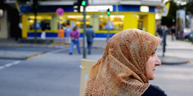 395629 01: A Muslim woman waits to cross a street October 10, 2001 in Berlin's heavily-Muslim Neukoelln district. Investigators are revealing that Germany has been a major hub for Osama bin Laden's Al-Qaida organization, and that his followers successfully exploited the country's liberal society and large Muslim population to gain technical education, open bank accounts and recruit new members. (Photo by Sean Gallup)