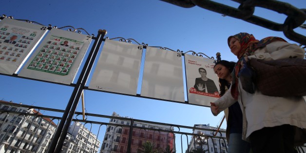 Women walk by electoral campaign posters for the upcoming legislative elections in Algiers centers, Algeria, on April 12 , 2017. (Photo by Billal Bensalem/NurPhoto via Getty Images)