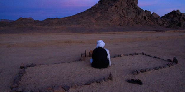 TAMANRASSET, ALGERIA -JANUARY 31: January 31st, 2012,town of Tamanrasset, Algeria. This man has delimited his prayer space with a few stones lined up on the bare ground while, before him, the volcanic region of Tamanrasset stretches out as far as the eye can see. On some rock faces, paintings dating from the Paleolithic age have stood the test of time despite the heavy tourism in the area. (Photo by Reza/Getty Images)