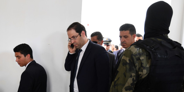 Tunisian Prime Minister Youssef Chahed talks on the phone upon his arrival in the town of Tataouine on April 27, 2017.
Chahed was booed off stage as he addressed a town hall meeting in the southeastern region rocked by protests and a general strike. Chahed and several government ministers arrived in the town of Tataouine to find a town closed down by a general strike. / AFP PHOTO / Fethi Belaid (Photo credit should read FETHI BELAID/AFP/Getty Images)