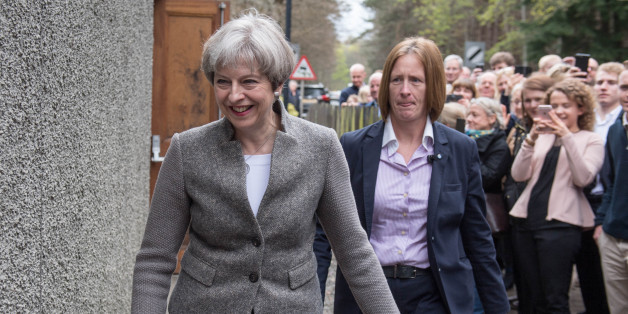 Britain's Prime Minister Theresa May (C) goes door-to-door campaigning for Andrew Bowie, Conservative candidate for West Aberdeenshire and Kincardine in the village of Banchory, in Aberdeenshire, north east of Scotland, on April 29, 2017 during a general election campaign visit.
Britain goes to the polls to elect a new parliament in a general election on June 8. / AFP PHOTO / Michal Wachucik (Photo credit should read MICHAL WACHUCIK/AFP/Getty Images)