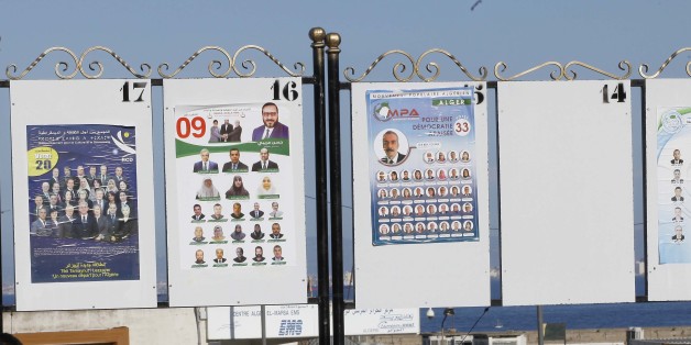 People sit under electorial campaign posters for the upcoming legislative elections in Algiers centers, Algeria, on April 12 , 2017. (Photo by Billal Bensalem/NurPhoto via Getty Images)