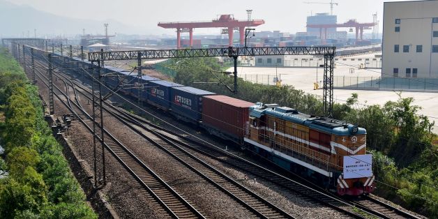 A freight train transporting containers laden with goods from London, arrives at Yiwu railway port station in Yiwu, east China's Zhejiang province on April 29, 2017. Laden with whisky and baby milk, the first freight train linking China directly to the UK arrived in the eastern Chinese city of Yiwu on April 29 after a 12,000-kilometre (7,500-mile) trip, becoming the world's second-longest rail route. / AFP PHOTO / STR / China OUT (Photo credit should read STR/AFP/Getty Images)
