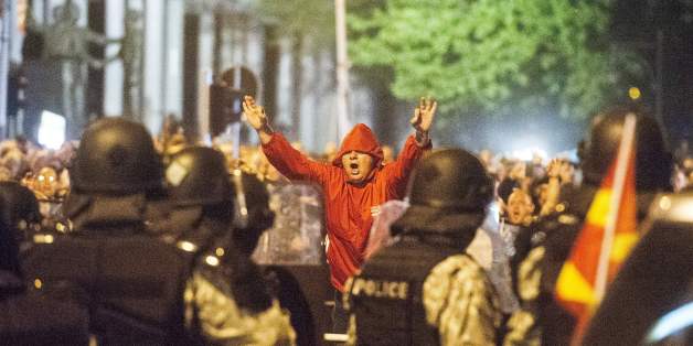 Police face protesters gathered outside Macedonia's parliament after the governing Social Democrats and ethnic Albanian parties voted to elect an Albanian as parliament speaker in Skopje on April 27, 2017.
Macedonia's opposition leader was among at least 10 people injured in parliament on April 27 after protesters stormed the building following an allegedly unfair vote for a parliamentary speaker, witnesses and local media reported. The violence erupted after around 100 protesters supporting the rival VMRO-DPMNE party entered parliament waving Macedonian flags and singing the national anthem.
/ AFP PHOTO / Robert ATANASOVSKI (Photo credit should read ROBERT ATANASOVSKI/AFP/Getty Images)