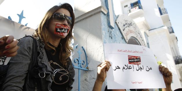Tunisian journalists protest in Tunis October 17, 2012. Tunisian journalists went on strike on Wednesday, piling pressure on the Islamist government they accuse of restricting freedom of speech after a revolt toppled the country's autocratic leader last year. Tunisia's once-staid media has enjoyed a new lease of life since the removal of Zine al-Abidine Ben Ali, but activists say the government, led by the moderate Islamist Ennahda party, is now seeking to impose new controls. The placard reads: