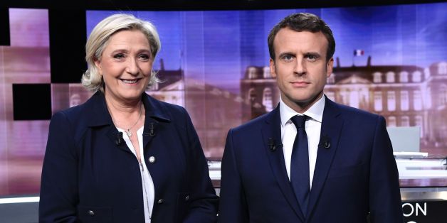 French presidential election candidate for the far-right Front National (FN) party, Marine Le Pen (L) and French presidential election candidate for the En Marche ! movement, Emmanuel Macron pose prior to the start of a live brodcast face-to-face televised debate in television studios of French public national television channel France 2, and French private channel TF1 in La Plaine-Saint-Denis, north of Paris, on May 3, 2017 as part of the second round election campaign.
Pro-EU centrist Emmanuel Macron and far-right leader Marine Le Pen face off in a final televised debate on May 3 that will showcase their starkly different visions of France's future ahead of this weekend's presidential election run-off. / AFP PHOTO / POOL / Eric FEFERBERG / ALTERNATIVE CROP (Photo credit should read ERIC FEFERBERG/AFP/Getty Images)