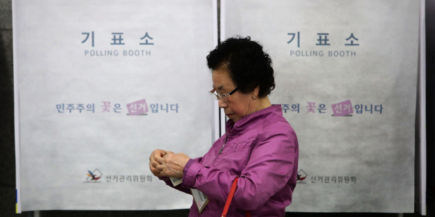 SEOUL, SOUTH KOREA - MAY 04: A South Korean woman leaves after casting her preliminary vote in a polling station on May 4, 2017 in Seoul, South Korea. Preliminary voting has started at local polling stations across South Korea prior to the primary Presidential election on May 9, 2017. (Photo by Chung Sung-Jun/Getty Images)