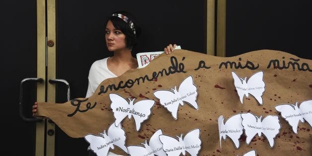 A woman takes part in a demonstration in front of the Guatemala embassy in Panama City on March 14, 2017 to demand justice for the death of 34 girls in a recent fire at a state-run children's shelter in San Jose Pinula, Guatemala. / AFP PHOTO / Rodrigo ARANGUA (Photo credit should read RODRIGO ARANGUA/AFP/Getty Images)