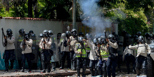 Riot police crack down on students at the Central University of Venezuela during clashes in a protest against the government of Nicolas Maduro in Caracas on May 4, 2017.Anti-government protests raged on in Venezuela Thursday as students launched fresh marches after a day of flames and tear gas brought the death toll to 33. / AFP PHOTO / FEDERICO PARRA (Photo credit should read FEDERICO PARRA/AFP/Getty Images)