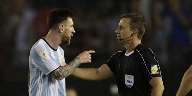 Argentina's forward Lionel Messi (L) argues with first assistant referee Emerson Augusto de Carvalho at the end of their 2018 FIFA World Cup Russia South American qualifier football match against Chile, at the Monumental stadium in Buenos Aires, on March 23, 2017. The FIFA on March 28, 2017 suspended Messi for four Argentina games. / AFP PHOTO / JUAN MABROMATA (Photo credit should read JUAN MABROMATA/AFP/Getty Images)