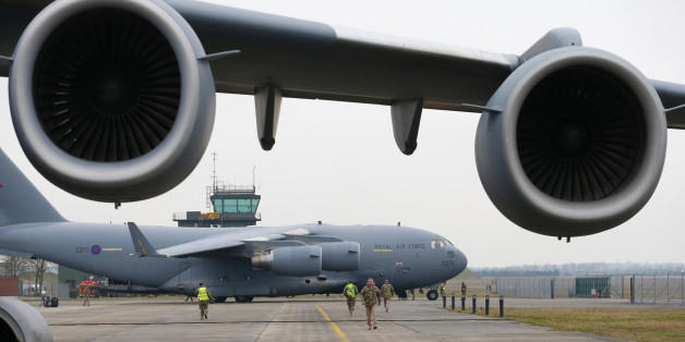 A broken down Royal Air Force C-17 stands in the foreground as another prepares to be loaded with French military equipment at Evreux in northern France, January 14, 2013. Britain is lending logistical support to France as it sends troops and military equipment to Mali. REUTERS/Andrew Winning (FRANCE - Tags: MILITARY POLITICS)