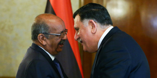 Algeria's Minister Delegate for Maghreb and African Affairs, Abdelkader Messahel (L), shakes hands with with Libyan Prime Minister Fayez al-Sarraj in the capital Tripoli on April 21, 2017. / AFP PHOTO / MAHMUD TURKIA (Photo credit should read MAHMUD TURKIA/AFP/Getty Images)