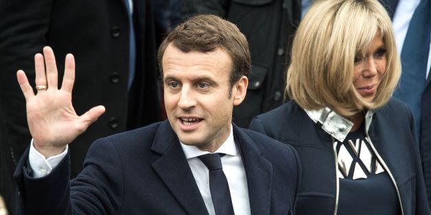 French presidential election candidate for the En Marche ! movement Emmanuel Macron waves to supporters next to his wife Brigitte Trogneux on May 7, 2017, in Le Touquet, northern France, after voting for the second round of the French presidential election. / AFP PHOTO / PHILIPPE HUGUEN (Photo credit should read PHILIPPE HUGUEN/AFP/Getty Images)