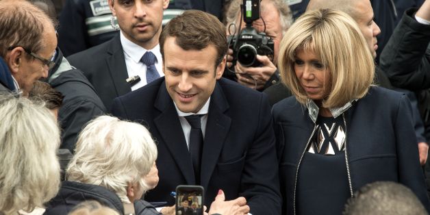 French presidential election candidate for the En Marche ! movement Emmanuel Macron (C), next to his wife Brigitte Trogneux (R), speaks with supporters in Le Touquet, northern France, on May 7, 2017, after voting for the second round of the French presidential election. / AFP PHOTO / PHILIPPE HUGUEN (Photo credit should read PHILIPPE HUGUEN/AFP/Getty Images)
