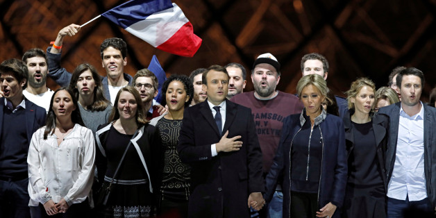 French President elect Emmanuel Macron and his wife Brigitte Trogneux celebrate on the stage at his victory rally near the Louvre in Paris, France May 7, 2017. REUTERS/Benoit Tessier