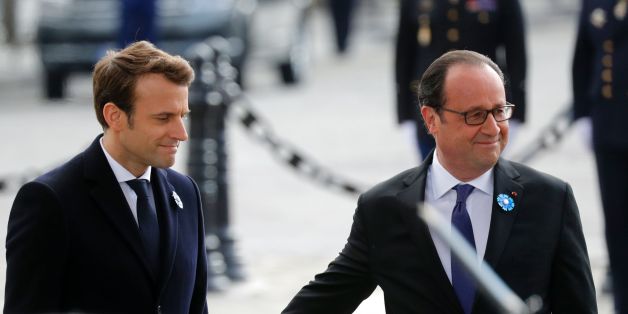 Outgoing French President Francois Hollande (R) touches the arm of President-elect Emmanuel Macron (L) as they stand at the Tomb of the Unknown Soldier at the Arc de Triomphe during a ceremony marking the 72nd anniversary of the victory over Nazi Germany during World War II on May 8, 2017 in Paris. / AFP PHOTO / POOL / PHILIPPE WOJAZER (Photo credit should read PHILIPPE WOJAZER/AFP/Getty Images)