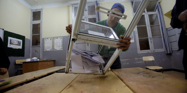An election worker empties a ballot box at the end of voting for the parliamentary election at a polling station in Algiers, Algeria, May 4, 2017. REUTERS/Ramzi Boudina