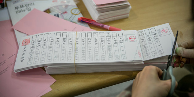 SEOUL, SOUTH KOREA - MAY 09: A South Korean polling worker organizes voting papers before giving out to voters at a polling site on the presidential election on May 9, 2017 in Seoul, South Korea. Polls have opened in South Korea's presidential election, called seven months early after former President Park Geun-hye was impeached for her involvement in a corruption scandal. (Photo by Jean Chung/Getty Images)