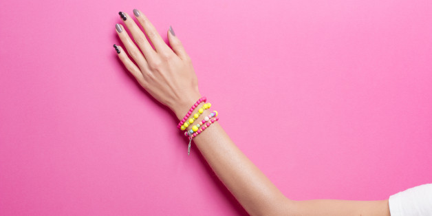 Single woman hand, wearing jewelry, in various background colors. Graphic look, solid bold colors, close up shot.