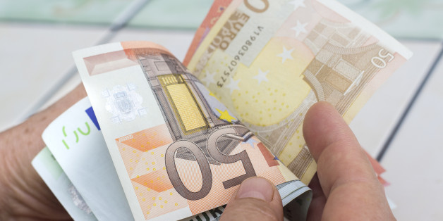 Close-up view of unrecognizable man counting money. Horizontal composition. Studio shot. Image developed from RAW format.