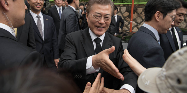 South Korean President Moon Jae-In greets supporters outside his home Seoul on May 10, 2017.Left-leaning former human rights lawyer Moon Jae-In began his five-year term as president of South Korea following a landslide election win after a corruption scandal felled the country's last leader. / AFP PHOTO / Ed JONES (Photo credit should read ED JONES/AFP/Getty Images)