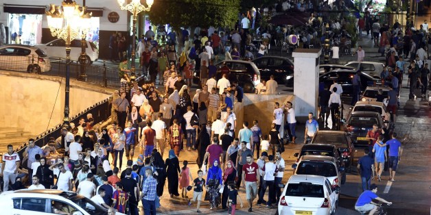 TO WITH AFP STORY BY AMER OUALI Algerians gather outside Algiers' Grand Post Office during the Muslim holy fasting month of Ramadan on July 12, 2015. During Ramadan the Algerian capital comes alive with animation largely subsidized by the government to prevent the young from becoming strongly influenced by the Imams in this pious period. AFP PHOTO / FAROUK BATICHE (Photo credit should read FAROUK BATICHE/AFP/Getty Images)