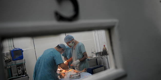 Algerian doctors circumcise a boy during a mass circumcision at a local hospital September 27, 2008. in Algiers. The Muslim religion stresses cleanliness, and circumcision in many Islamic nations is considered a form of natural hygiene, with the event being often viewed communally as a joyous occasion and celebrated. AFP PHOTO/FAYEZ NURELDINE (Photo credit should read FAYEZ NURELDINE/AFP/Getty Images)