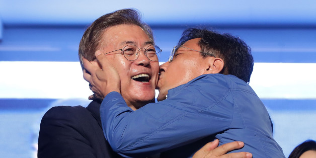 SEOUL, SOUTH KOREA - MAY 09: South Chungcheong governor An Hee-jung kisses South Korean President-elect Moon Jae-in, of the Democratic Party of Korea, at Gwanghwamun Square on May 9, 2017 in Seoul, South Korea. Moon Jae-in declared victory in South Korea's presidential election, which was called seven months early after former President Park Geun-hye was impeached for her involvement in a corruption scandal. (Photo by Chung Sung-Jun/Getty Images)