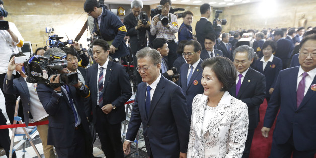 Newly elected South Korean President Moon Jae-in (L) and his wife Kim Jung-suk leave after his inauguration ceremony at the National Assembly in Seoul on May 10, 2017. Moon was sworn in just a day after a landslide election victory, and immediately declared his willingness to visit Pyongyang amid high tensions with the nuclear-armed North. / AFP PHOTO / POOL / Ahn Young-joon (Photo credit should read AHN YOUNG-JOON/AFP/Getty Images)