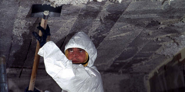 A worker removes asbestos (amiante) cement from the ceiling in a primary school in Nantes after France announced a ban on asbestos from 1997. A study predicted that some 2000 people would die this year from exposure to the industrial fibre.