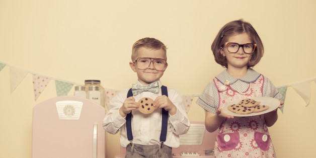 Two children dressed as a married couple love cookies.