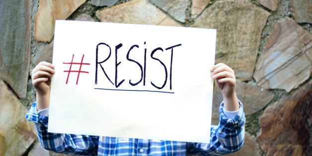 Boy holding resist sign