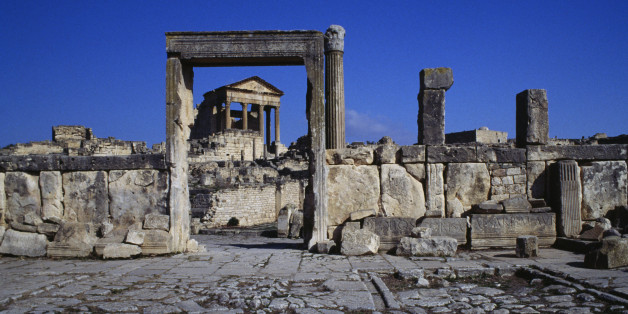 TUNISIA - MAY 12: View of the Capitolium (Capitol), 166-167 AD, through the doorway of the Dar Lacheb (House of Lacheb), 164-166 AD, Thugga, Dougga (Unesco World Heritage List, 1997), Tunisia. Roman civilisation, 2nd century AD. (Photo by DeAgostini/Getty Images)