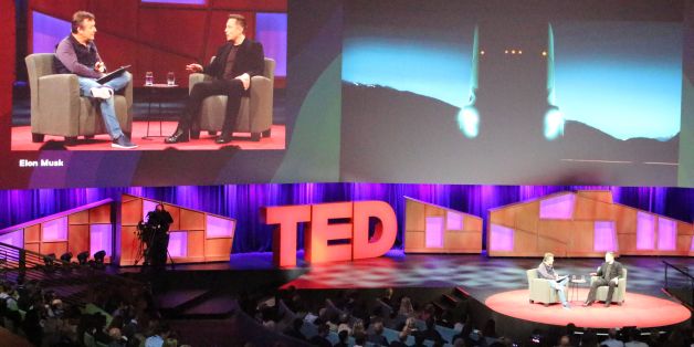 Tesla chief Elon Musk (R) provides a teasing glimpse at a self-driving cargo truck being developed by the California-based electric vehicle company during a chat with Chris Anderson (L) at a TED Conference in Vancouver, Canada, April 28, 2017. / AFP PHOTO / Glenn CHAPMAN (Photo credit should read GLENN CHAPMAN/AFP/Getty Images)