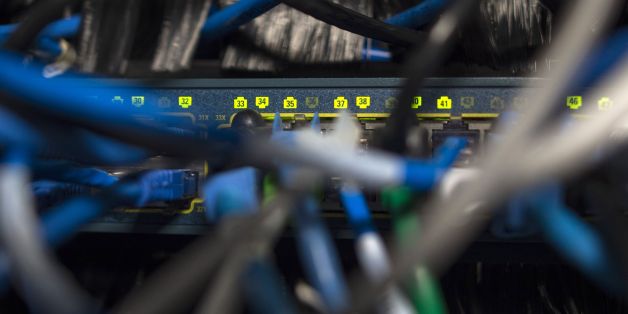 Network cables are seen going into a server in an office building in Washington, DC on May 13, 2017.
International investigators hunted on May 13 for those behind an unprecedented cyber-attack that affected systems in dozens of countries, including at banks, hospitals and government agencies, as security experts sought to contain the fallout. The assault, which began Friday and was being described as the biggest-ever cyber ransom attack, struck state agencies and major companies around the world -- from Russian banks and British hospitals to FedEx and European car factories. / AFP PHOTO / Andrew CABALLERO-REYNOLDS (Photo credit should read ANDREW CABALLERO-REYNOLDS/AFP/Getty Images)
