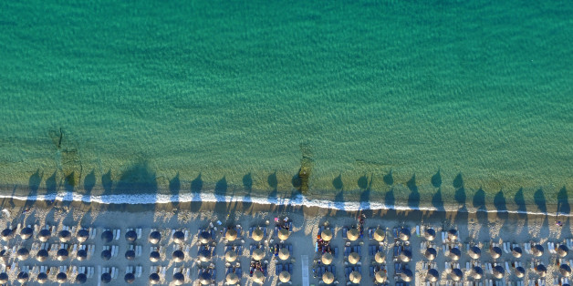 HALKIDIKI, GREECE - JUNE 23: Aerial view of The Pefkochori beach with umbrellas on June 23, 2015 in Halkidiki, Greece. Pefkochori is a tourist town located in the southeast of the peninsula of Kassandra and named after the pine trees which are abundant in the mountains of the area. (Photo by Athanasios Gioumpasis/Getty Images)