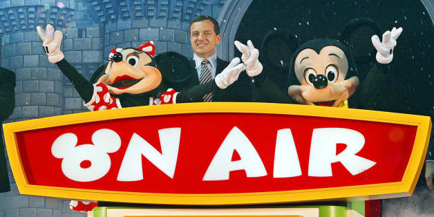 TOKYO, JAPAN: President and chief operating officer Rob Iger (C), Mickey Mouse (R) and Minnie Mouse (L) attend the launch of the 24-hour Disney exclusive channel 'Disney Channel' in Japan, during the opening ceremony in Tokyo, 18 Noember 2003. The launch coincides to mark the 75th birthday of Mickey Mouse. AFP PHOTO/Toru YAMANAKA (Photo credit should read TORU YAMANAKA/AFP/Getty Images)