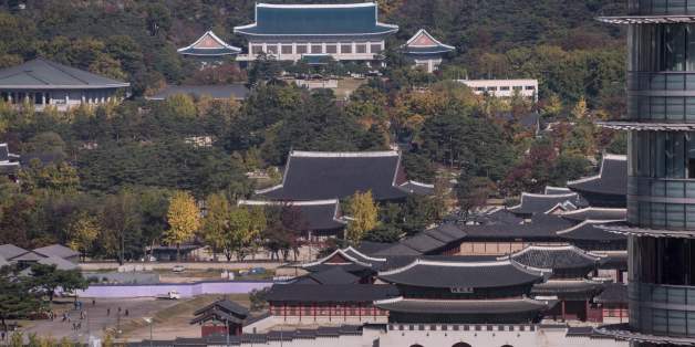 A general view shows Gyeongbokgung palace and the presidential Blue House (top C) in Seoul on November 1, 2016.The woman at the centre of the snowballing political scandal engulfing President Park Geun-Hye is a 'flight risk' and has been placed under emergency detention, South Korean prosecutors said. Choi Soon-Sil, who faces allegations of fraud and meddling in state affairs over her decades-long friendship with Park, was grilled for hours Monday after she returned to the country and handed her