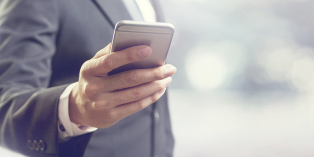 Close up of a business man using mobile smart phone, copy space.