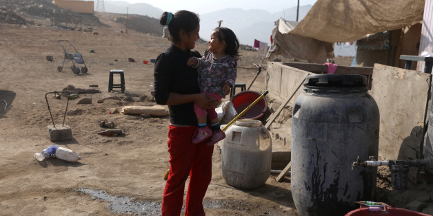 Katia and her daughter Guadalupe stand outside their house in Villa Maria del Triunfo, a shanty town on the outskirts of Lima, Peru May 9, 2017. REUTERS/Guadalupe Pardo