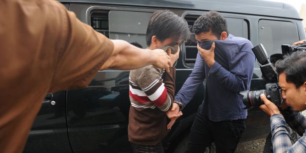 Two Indonesian men arrive for their trials at a shariah court in Banda Aceh on May 17, 2017. A sharia court on May 17 sentenced two men to be publicly caned for gay sex for the first time in Indonesia's conservative province of Aceh, the latest sign of a backlash against homosexuals in the Muslim-majority country. / AFP PHOTO / CHAIDEER MAHYUDDIN (Photo credit should read CHAIDEER MAHYUDDIN/AFP/Getty Images)