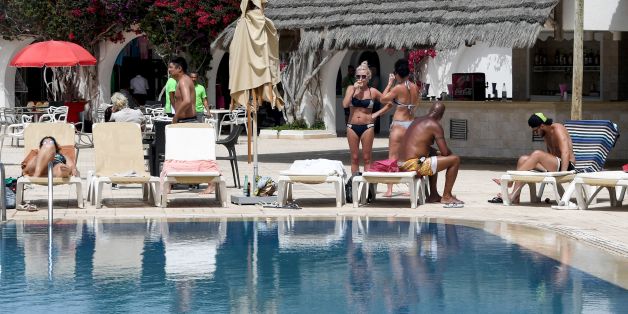 European tourists sunbathe at a hotel in the southern Mediterranean Tunisian resort island of Djerba, on May 13, 2017. / AFP PHOTO / FETHI BELAID (Photo credit should read FETHI BELAID/AFP/Getty Images)