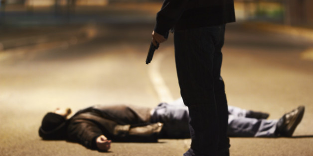 Man lying on the ground after being shot by a gun-wielding criminal