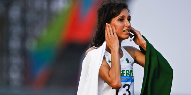 PALEMBANG, SOUTH SUMATRA, INDONESIA - SEPTEMBER 26: Amina Bettiche of Algeria celebrates after winning the women's 3000 meter Steeplechase final as part of the 3rd Islamic Solidarity Games at Jakabaring Sport complex on September 26, 2013 in Palembang, South Sumatra, Indonesia. (Photo by Ulet Ifansasti/Getty Images)