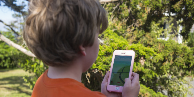 An unidentified boy searches his handset during a search with the Pokémon Go application in East Orleans, Massachusetts on July 10, 2016. (Photo by Robert Nickelsberg/Getty Images)