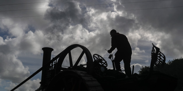 EXETER, ENGLAND - MAY 18: A man oils his steam engine being displayed at the 122nd Devon County Show at the Westpoint Arena and Showground in Clyst St Mary near Exeter on May 18, 2017 in Devon, England. Established in 1872 it has grown into one of the South West's biggest county shows and is often seen as a curtain raiser for the whole showing season. Although primarily a agricultural livestock and produce showcase, it is also seen as a barometer for the health of the whole agricultural industr